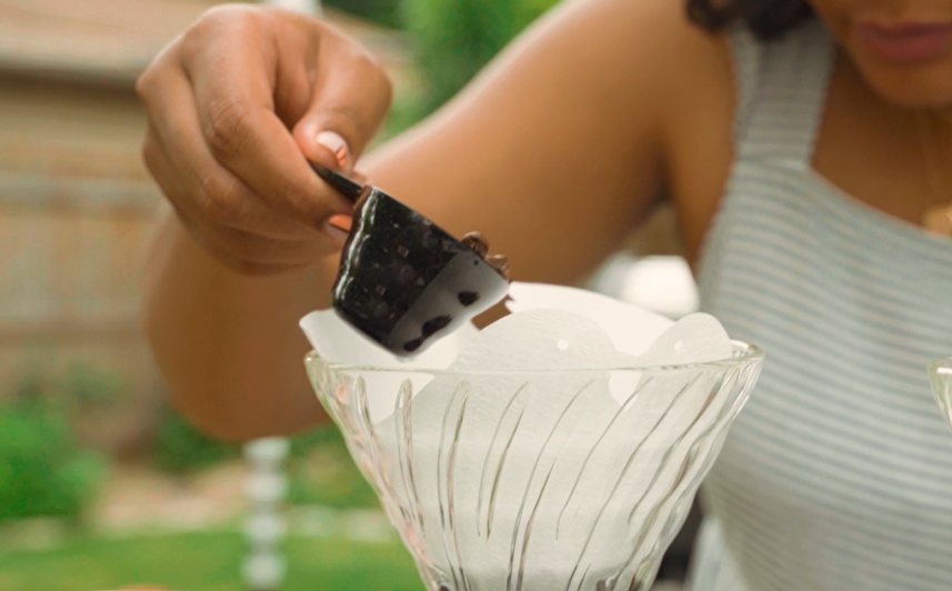beans being poured into the filter.